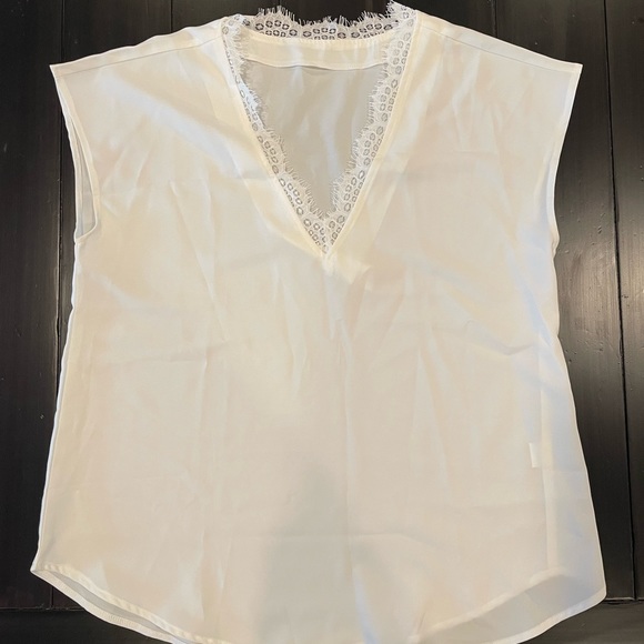 Tops - Medium white short sleeve shirt with lace accent around the neck.